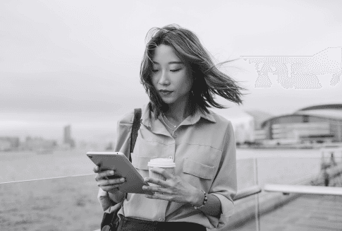 Professional reviewing coaching session content on a tablet device outdoors